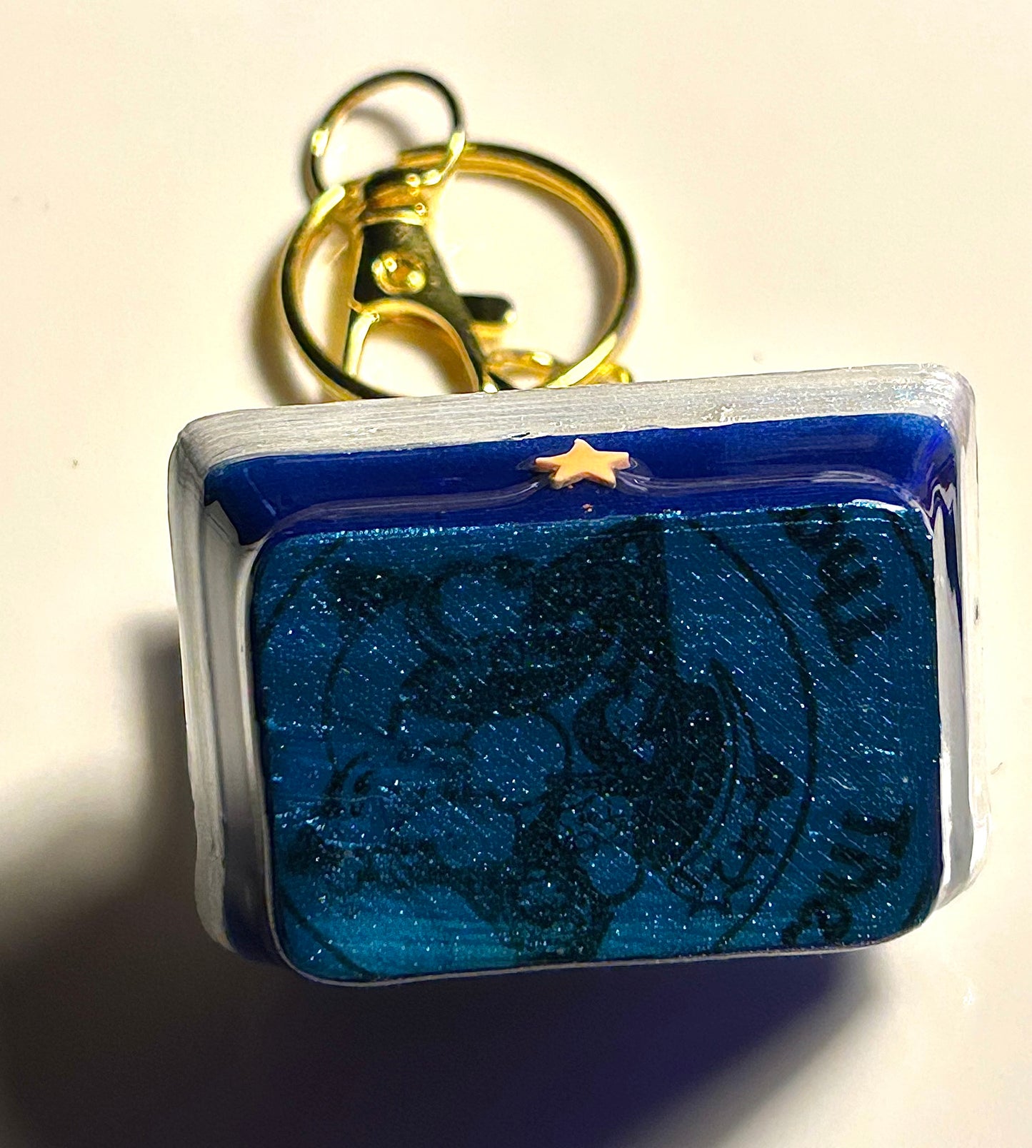 Under side of 3D modeled Golden nuggets in a box gold keychain