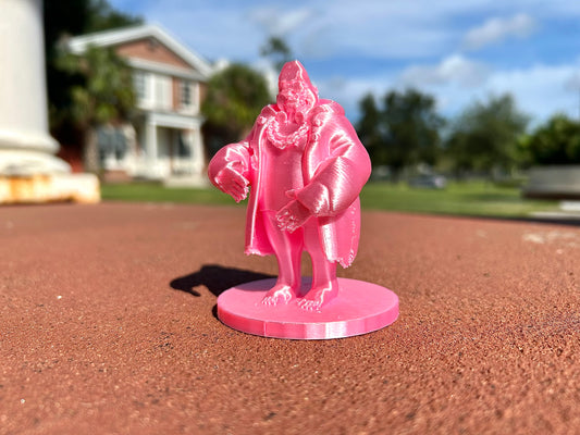 Pink Gorilla figurine on a baseball field with a blurred background