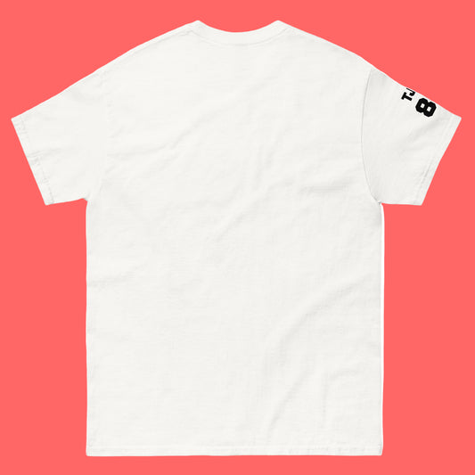 White t-shirt with a black logo on the sleeve against a pink background