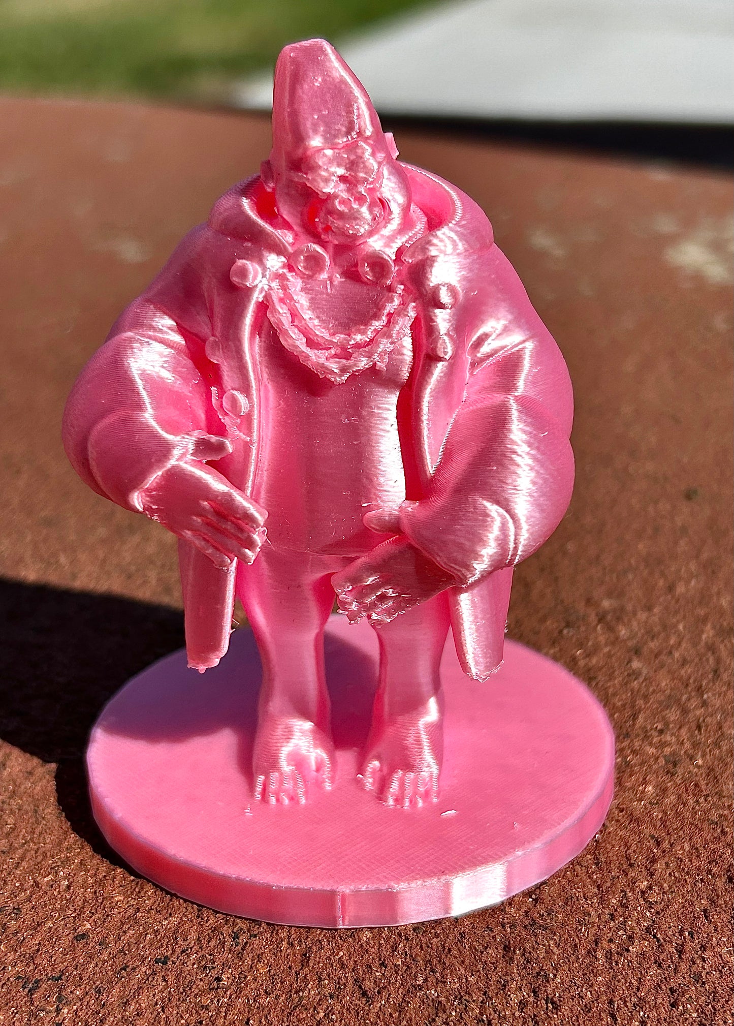 Pink Gorilla figurine on a baseball field with a blurred background
