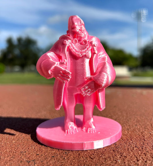 Pink Gorilla figurine on a baseball field with a blurred background