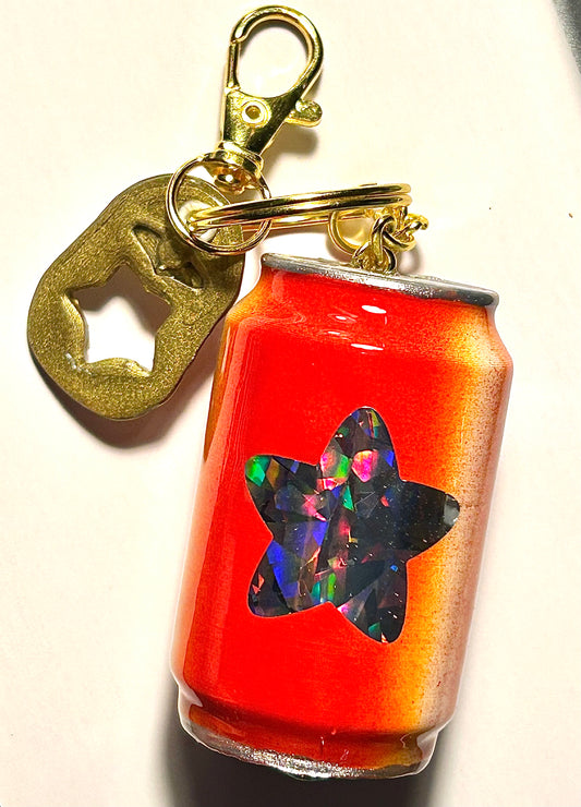 Keychain with a can-shaped soda and soda tab on a white background