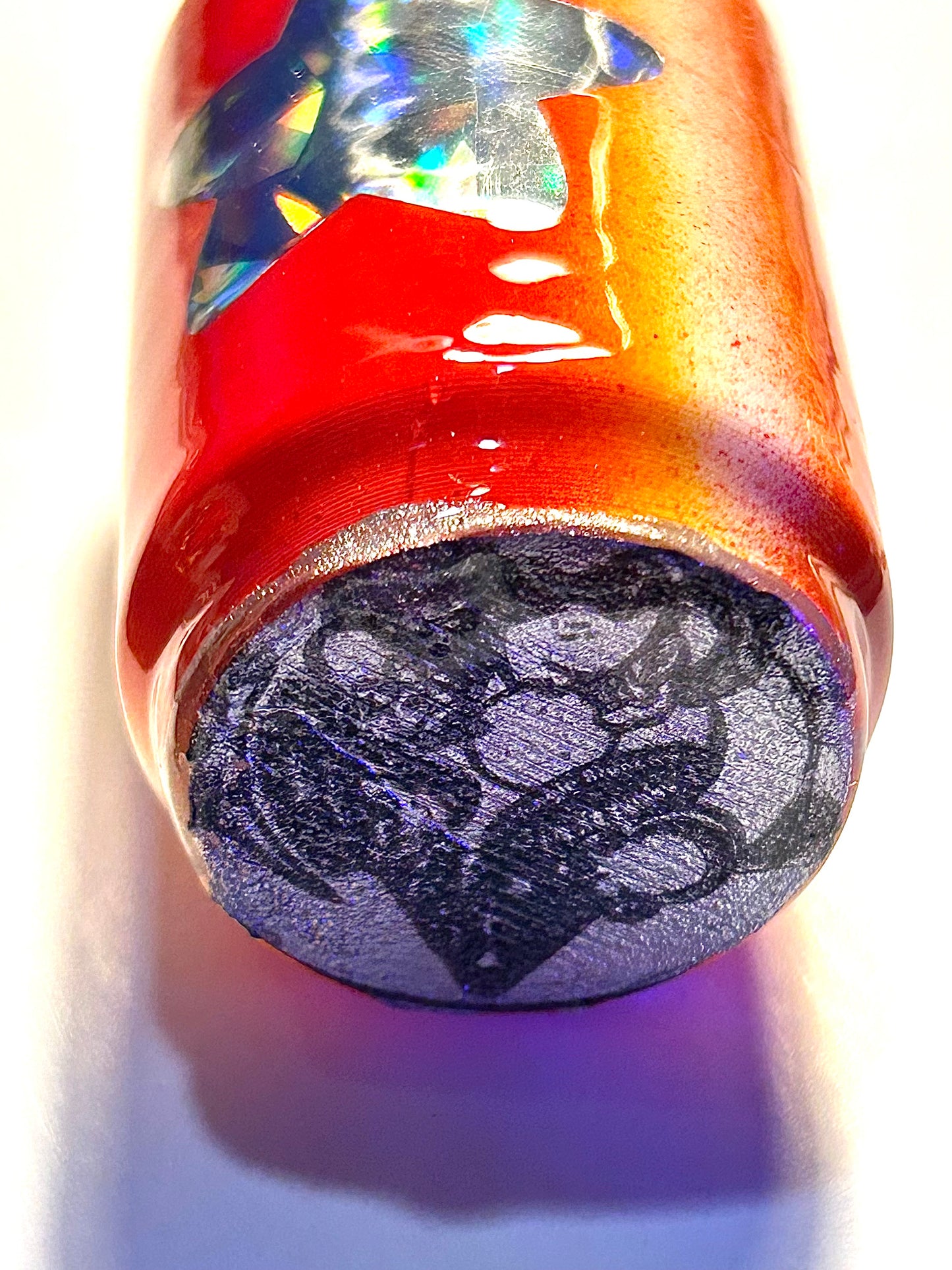 Keychain with a can-shaped soda and character logo underneath on a white background