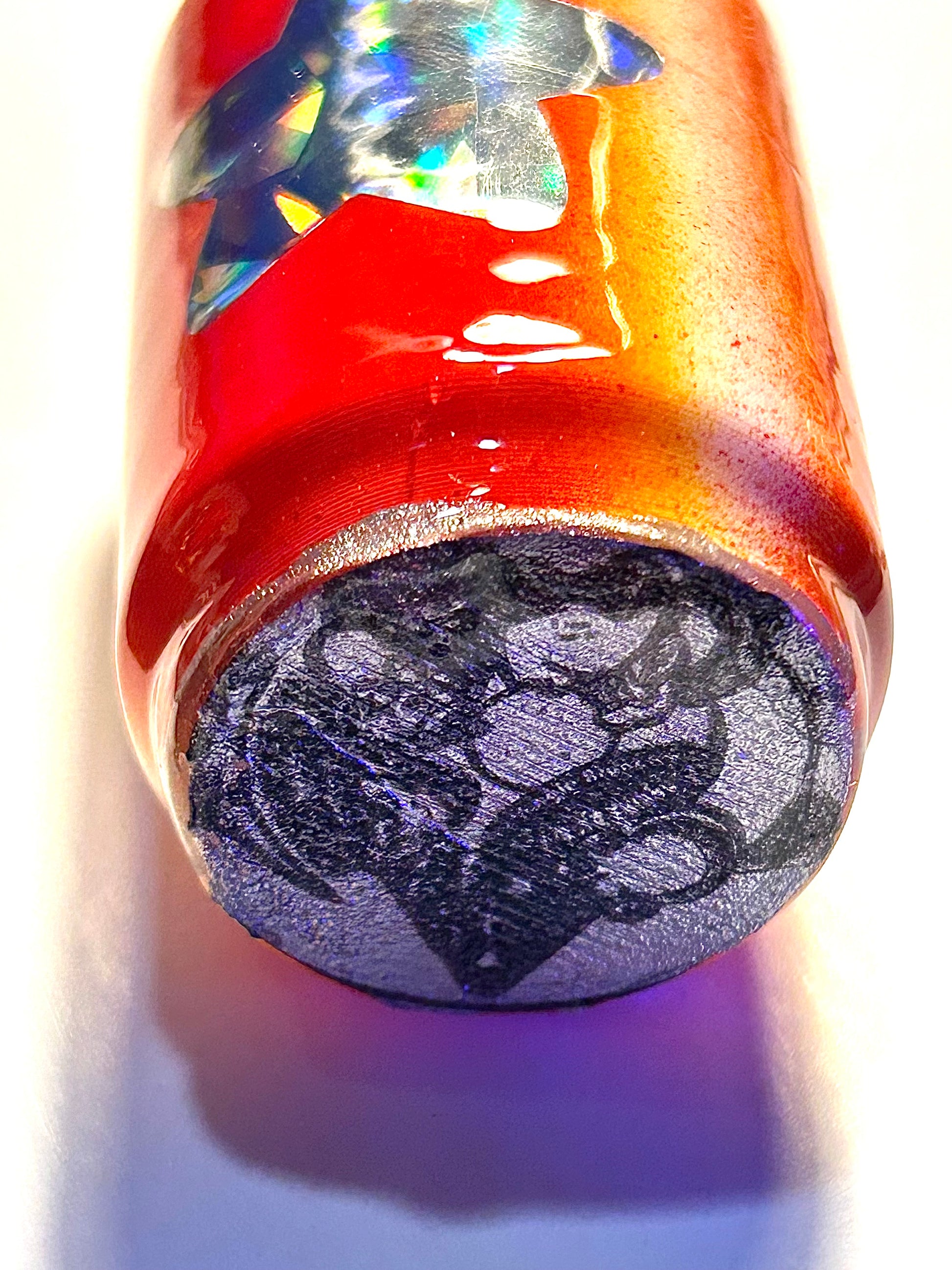 Keychain with a can-shaped soda and character logo underneath on a white background