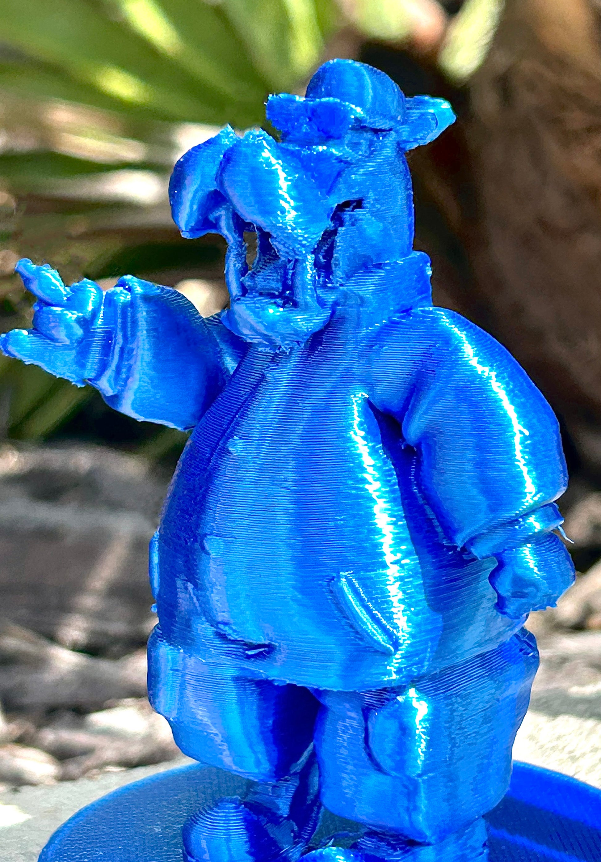 Blue McHippo 3D modeled figurine in forest background