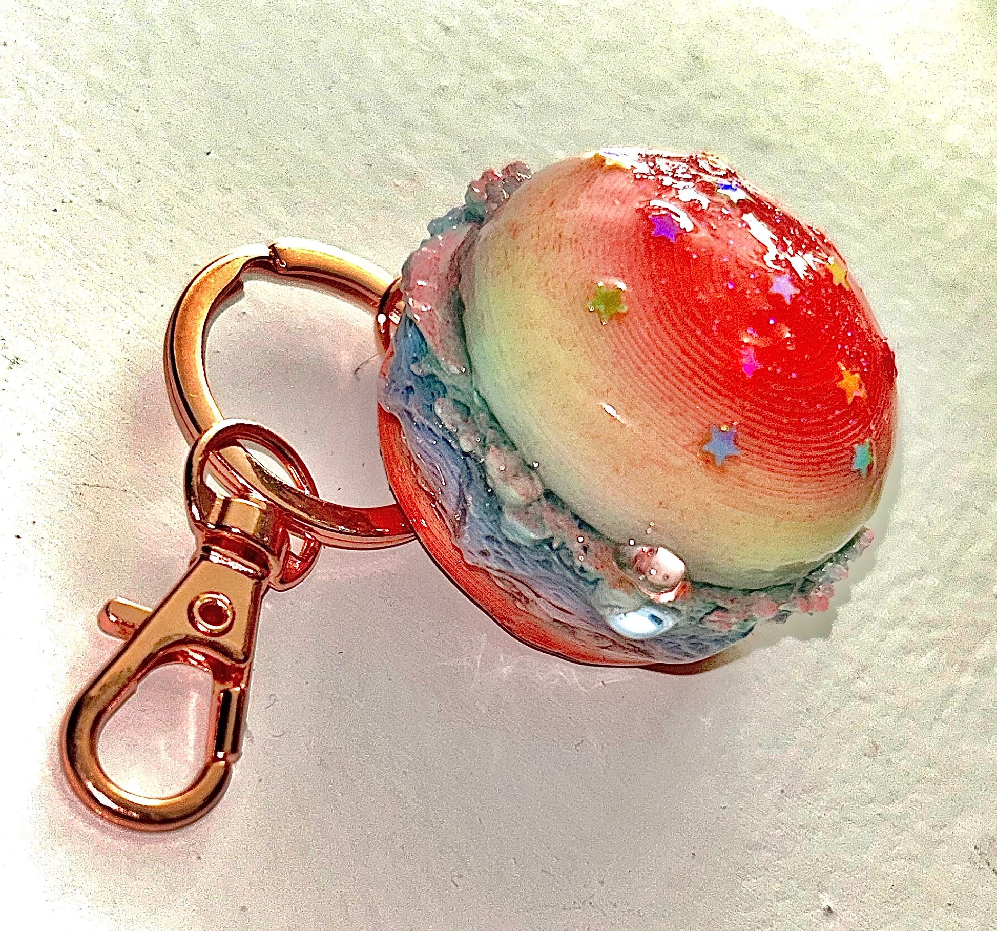 Burger Keychain with a colorful star sprinkles with spherical design on a white background