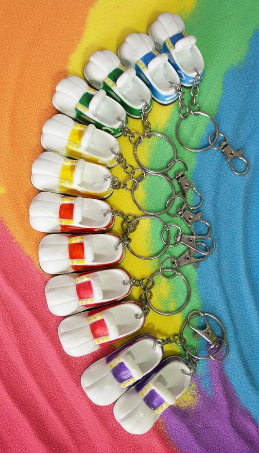 Set of colorful keychains shaped like small shoes on a rainbow background