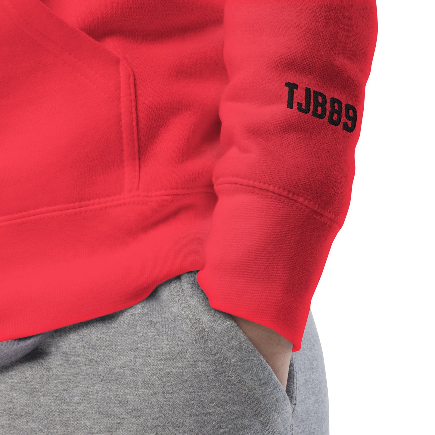 Red sweatshirt with 'TJBB9' on the sleeve against a white background