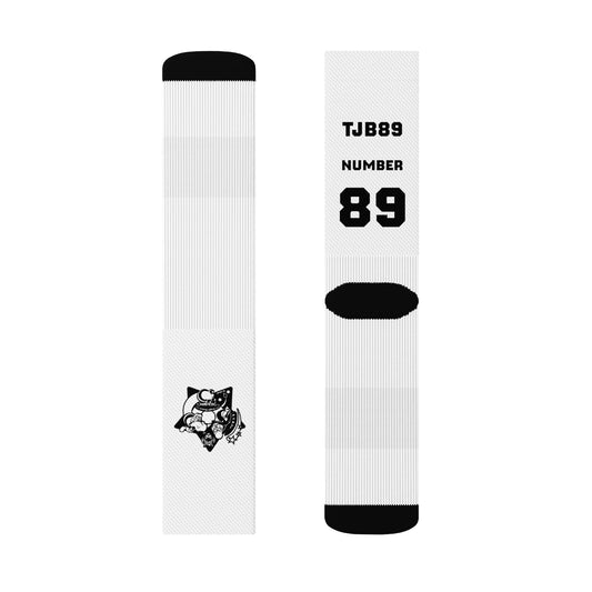 Two white socks with black accents and a logo on a white background